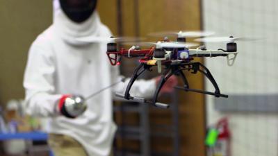 A person fencing with a drone