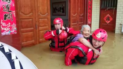 Old woman being rescued