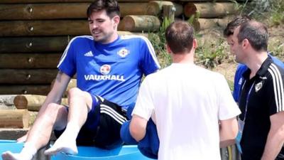 Northern Ireland striker Kyle Lafferty climbs into an ice bath after suffering an injury scare during training ahead of Sunday's Euro 2016 opener against Poland