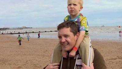 Man with son on Clacton beach
