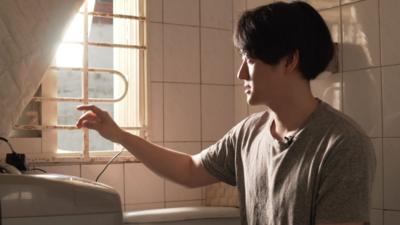 Man looks out of basement window