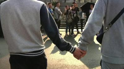 Gay couple holding hands