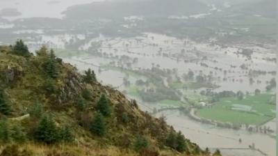 A man captures footage of Bassenthwaite Lake joining with Derwentwater as flooding hit Cumbria.