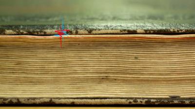 A closed book with a graphic of radiation waves superimposed on it