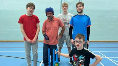 Boys stood with cricket gear