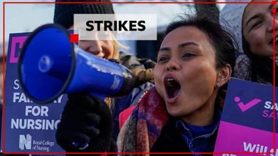 Striking nursing staff holding a megaphone and placards in Middlesbrough on 6 February 2023