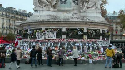 People laying flowers at Place de La Republique on Monday morning