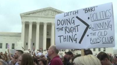 A sign saying "Ditch Bart" is held aloft outside the US Supreme Court in Washington D.C. on 6 October 2018