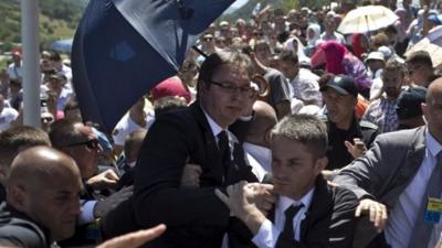 Aleksandar Vucic, Serbia"s prime minister, centrer, is seen during a scuffle at the Potocari memorial complex near Srebrenica