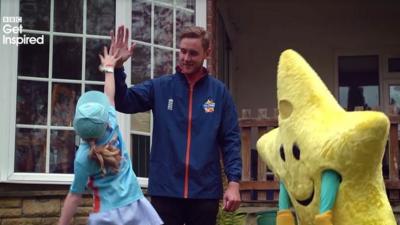 England bowler Stuart Broad high fives a young cricketer