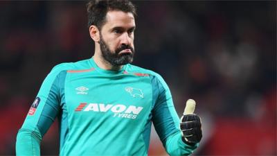 Derby goalkeeper Scott Carson gives his defence a thumbs up