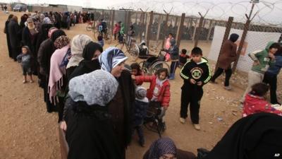 Syrian women wait in line to receive winter aid, Zaatari refugee camp in Mafraq, Jordan, 20 January 2016