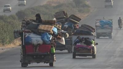 Displaced people flee fighting in north-western Syria