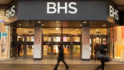 People walking in front of a BHS store