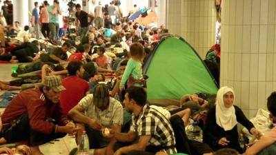 Migrants rest near Keleti train starion in Budapest, Hungary