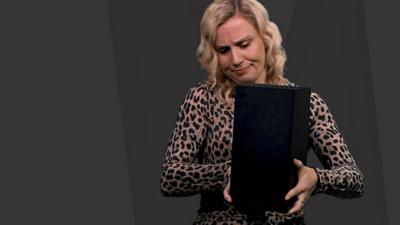 a-newsround-presenter-holding-an-xbox-series-x