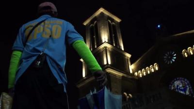 Person next to a church in Manila