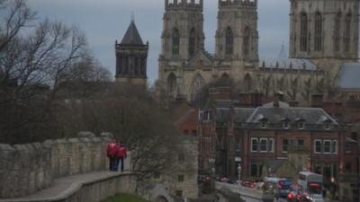 Harry Gration and Paul Hudson walk in front of York Minster