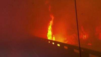 Flames raging along road in Texas wildfire