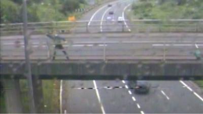 Man on motorway bridge