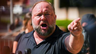 InfoWars founder Alex Jones speaks to the media outside court in Waterbury, Connecticut, on 21 September 2022