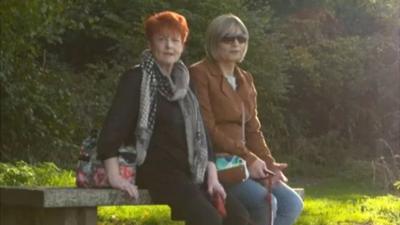 Lynne and Steff sitting on a park bench