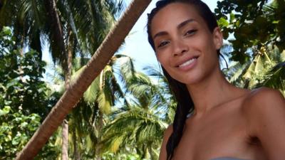 Ines Rau surrounded by palm trees