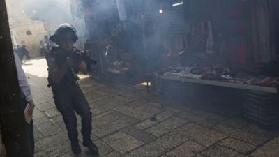 An Israeli border police office is see during clashes with Palestinian protesters in Jerusalem's old city