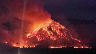 A mountain ablaze at nightime