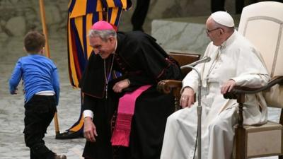 Boy with Pope Francis and Prefect of the Papal Household, Georg Ganswein