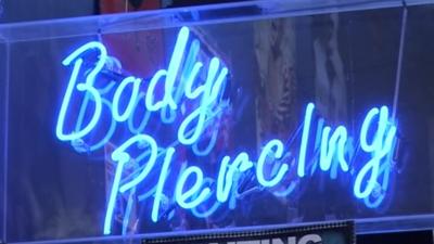 Body piercing sign