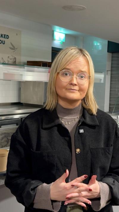 Catherine Moore has blonde hair and glasses.