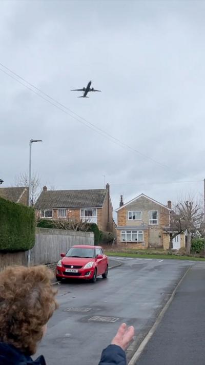 Plane flying over houses