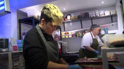 A cook in a restaraunt kitchen