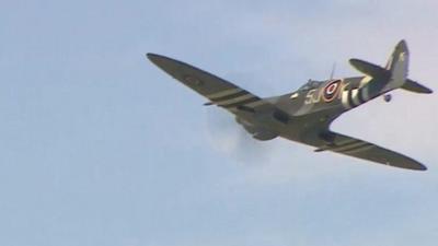 A Spitfire plane flying over London