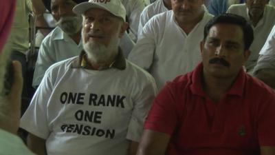 Retired Indian soldier wearing t-shirt with 'One Rank, One Pension' slogan