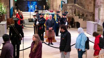 The King standing by his mother's coffin during the vigil in Edinburgh.