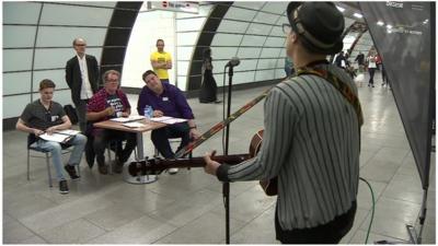 Judges watch busker audition at Tube station