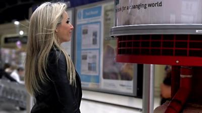 BBC Click reporter Lara Lewington stands next to an air filtering system at London Marylebone