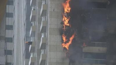 Flames on side of building