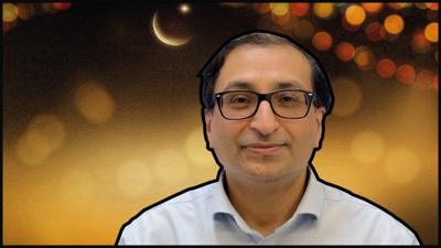 Dr Salim Modan in front of a Ramadan graphic