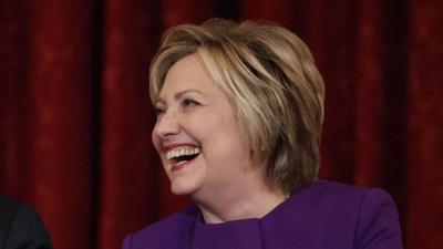 Hillary Clinton laughs in response to Joe Biden, out of frame