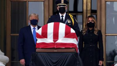 US President Donald Trump and Melania Trump behind Ruth Bader Ginsburg's casket