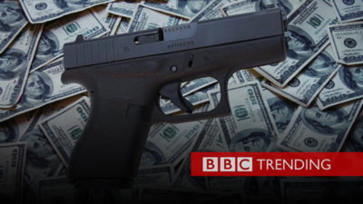 Picture of handgun with piles of dollars
