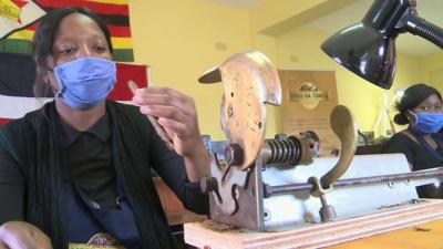 A woman making cigars in Zimbabwe