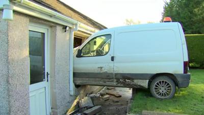 A van crashed through the window of a house