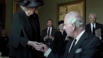 King Charles III hands pen to Camilla, Queen Consort