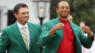 Tiger Woods is presented the Green Jacket by Patrick Reed