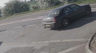 Car pulling out of a petrol station.