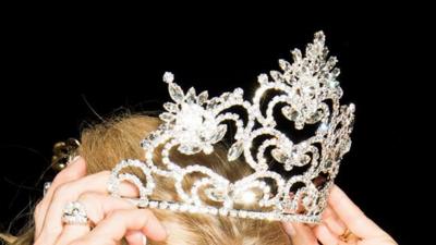 A contestant adjusts her tiara in the Miss Senior America beauty pageant 2016